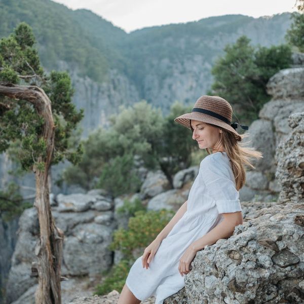 Person meditating in a calm, serene environment with soft lighting.